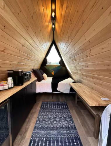a room with a bed in a wooden room at NEW! Unique Modern Glamping Chalet #5 in Orderville