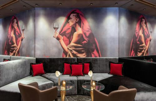 a wall with a painting of a woman holding a wine glass at Leonardo Royal Hotel Venice Mestre in Mestre