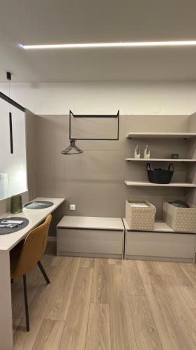 a kitchen with a desk and a table and a table and a chair at By The River Stay in Florina