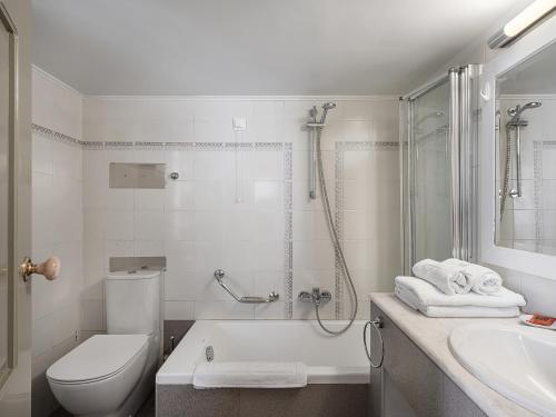 a bathroom with a shower and a toilet and a sink at Villa Andromeda in Chania