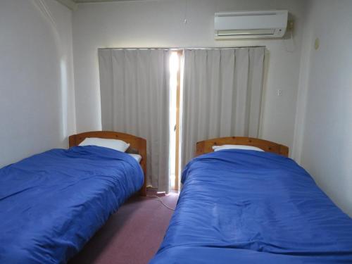 two beds sitting next to each other in a room at Belaire Ogata - Vacation STAY 32397v in Sanuki