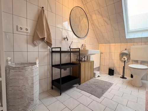 a bathroom with a sink and a toilet at Hallighafen in Bredstedt