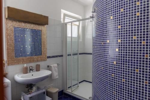 a bathroom with a sink and a glass shower at Casa Giordana in Torri del Benaco