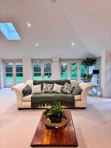 a living room with a couch and a table at The Baydon House Luxury Studio in Marlborough