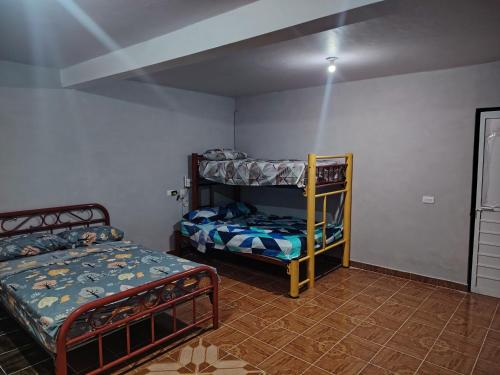 a bedroom with two bunk beds and a bed at Estancia kv in Coatepec
