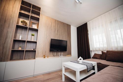 a living room with a couch and a tv at NeWave Apartment 2 in Strumica