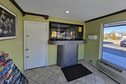 a kitchen with a counter in a room with a window at Sunrise Inn By OYO Newport News US-60 in Stoney Brook Estates
