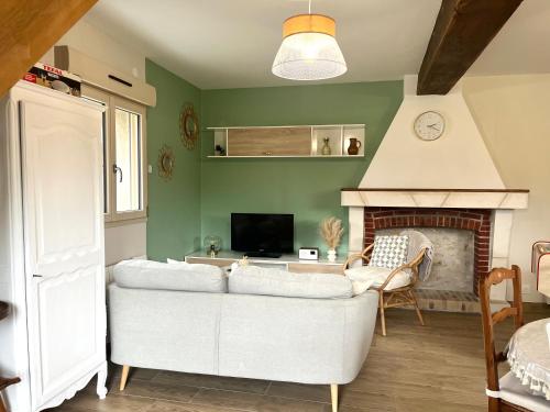 a living room with a couch and a fireplace at La Maison Agoméa in Saint-Georges-sur-Cher