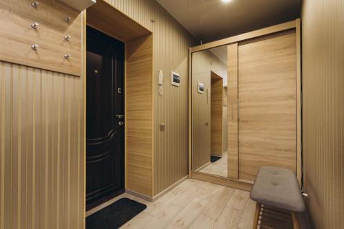 a hallway with a mirror and a walk in closet at Apart Center in Sumy