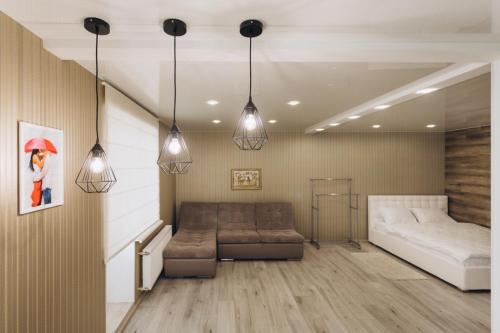a living room with a couch and a bed at Apart Center in Sumy