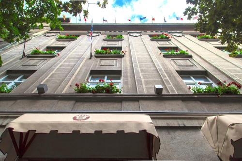 a building with flower boxes on the side of it at Hotel City Savoy in Belgrade