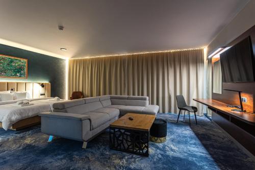 a hotel room with a couch and a bed at Hotel Marton in Koszalin