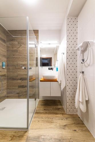 a bathroom with a shower and a sink at Hotel Marton in Koszalin