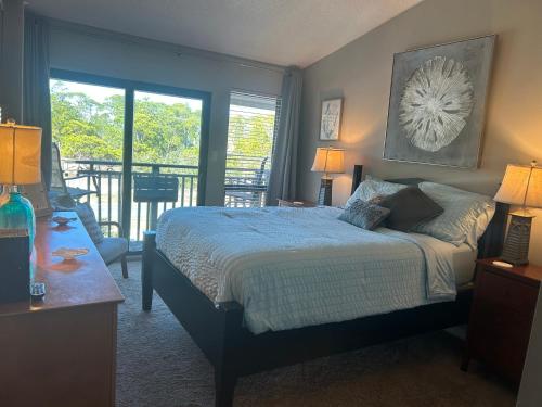 a bedroom with a bed and a balcony at Beautiful view from a peaceful place in St. George Island