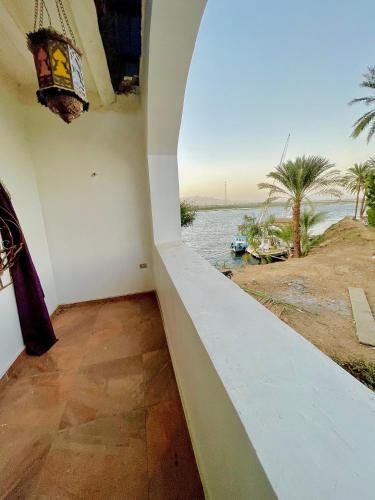 a room with a view of the water at Yellow House on the Nile in Luxor