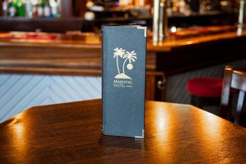 a book sitting on top of a wooden table at Majestic Hotel in Tramore