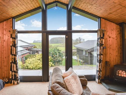 a living room with a large window and a couch at Glendowlin Lodge Retreat in Tirril