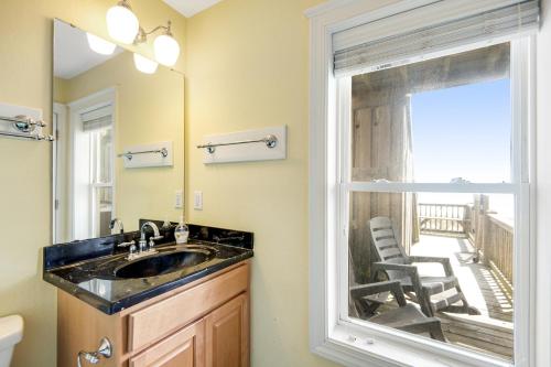 a bathroom with a sink and a window at NTB3886 Soulshine-Sunshine-Moonshine in North Topsail Beach