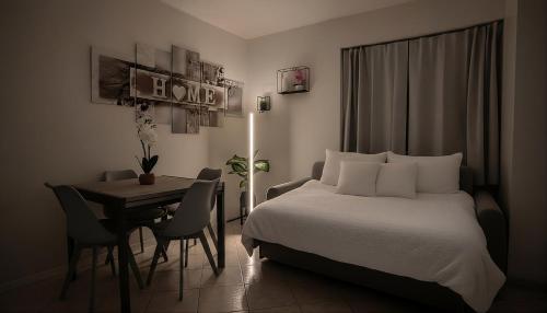 a bedroom with a bed and a table and a tableablish at Antonella's sweet home AIRPORT ORIO AL SERIO in Stezzano