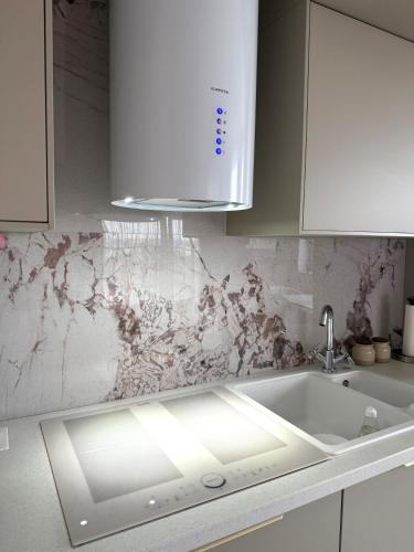 a kitchen with a sink and a white counter top at Louise Luxury - free parking in Nyíregyháza
