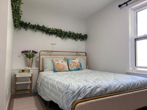 a bedroom with a bed with areath on the wall at Garden View near Confederation Bridge and Beaches in Borden-Carleton