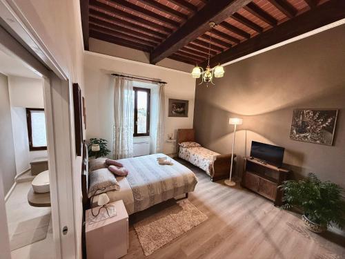 a bedroom with a bed and a television in it at Atelier Salvetti in Colle di Val d'Elsa