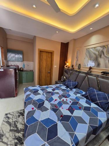 a bedroom with a large bed with a blue at The terrace affair studio with jacuzzi in Gurgaon
