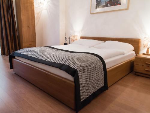 a bedroom with a large bed with white sheets at VacationClub - Morska 5 Apartment 4 in Kołobrzeg
