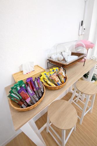 two baskets on a table with two stools at Phuket gateway inn in Kathu