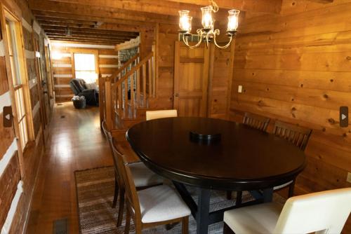a dining room with a table and chairs in a cabin at Governor's Private Cabin on Bourbon Trail w HotTub in Harrodsburg