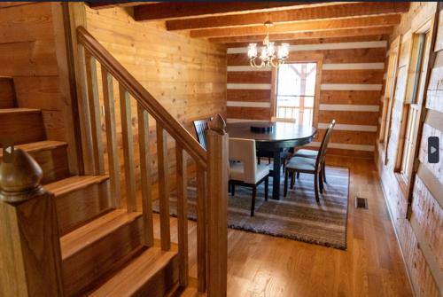 a dining room with a table in a log cabin at Governor's Private Cabin on Bourbon Trail w HotTub in Harrodsburg