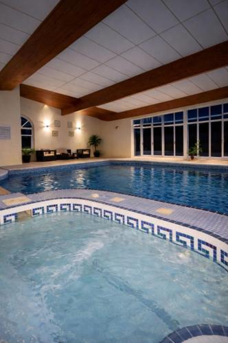 a large swimming pool in a large building at The Norwich Hideaway - Private Hot Tub in Norwich