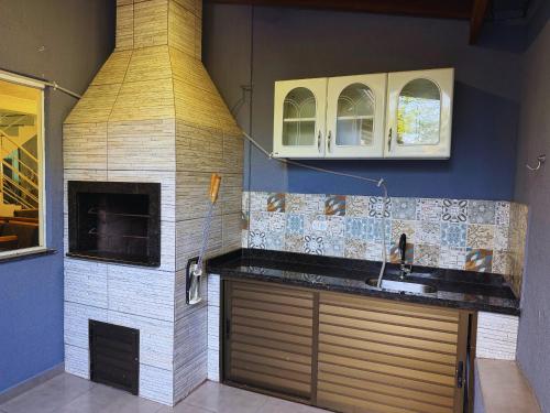 a kitchen with a brick oven and a sink at House in Yolanda Village in Foz do Iguaçu