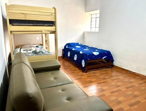 a living room with a couch and a bunk bed at Dionny's House in Tinco