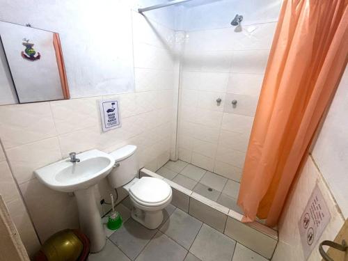 a bathroom with a toilet and a sink and a shower at Dionny's House in Tinco