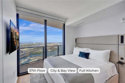 a bedroom with a bed and a large window at Miami Lux 1BR 37th Floor Bay City Views in Miami