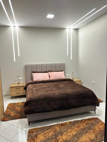 a bedroom with a large bed and two night stands at Με θέα το Κάστρο Apartment in Nafpaktos
