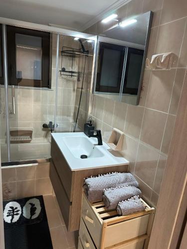 a bathroom with a sink and a shower at Με θέα το Κάστρο Apartment in Nafpaktos