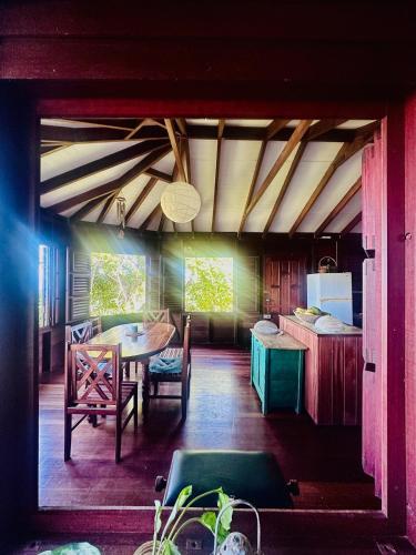 una sala da pranzo con un tavolo e sedie in una stanza di Hummingbird House a Calibishie