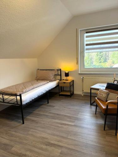 a bedroom with a bed and a window and a couch at emsRoom - Gästezimmer in Düne