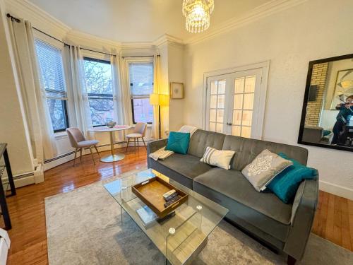 a living room with a couch and a table at Cozy 1Bed, 1Bath in Brookline, MBTA in Brookline