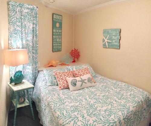 a bedroom with a bed with pillows on it at Casa Del Mar Beach View in Galveston