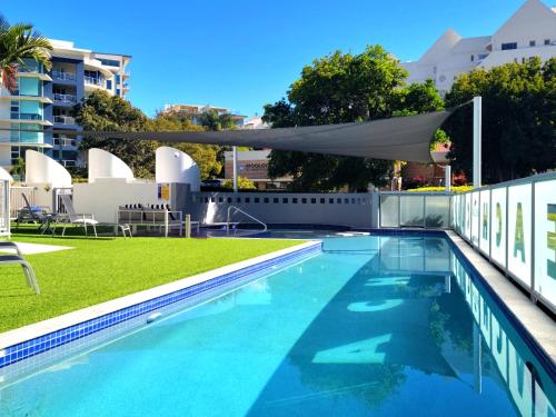 a swimming pool with a canopy on top of a building at Mooloolab Beach Paradise 2 bedroom Unit - 350m from Beach in Mooloolaba