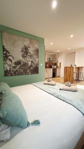 a large bed with two pillows on top of it at La suite canopée en Brocéliande in Campénéac