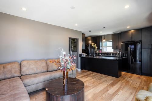 a living room with a couch and a table at Newly Renovated Bungalow w Free Parking 4min from SoFi, 8min from Airport in Los Angeles