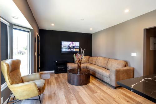 a living room with a couch and a table at Newly Renovated Bungalow w Free Parking 4min from SoFi, 8min from Airport in Los Angeles