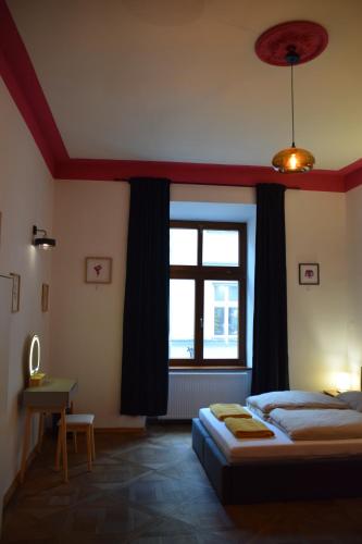 a bedroom with a bed and a large window at Apartment Tomasza 8 in Krakow