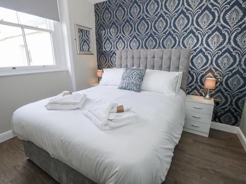 a bedroom with a large bed with two towels on it at Vista Mare 2 in Weymouth