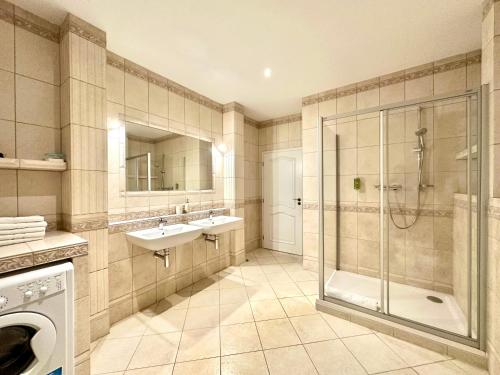 a large bathroom with a shower and a sink and a shower at Slunecni Lazne Apartments in Karlovy Vary