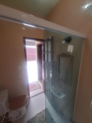 a bathroom with a toilet and a sink at Caminho das Pedras 206 in São Pedro da Aldeia